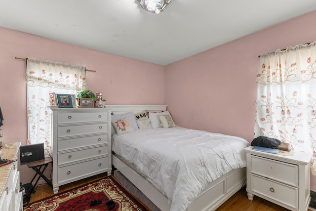 bedroom with dark wood-type flooring