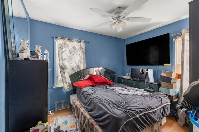 bedroom with hardwood / wood-style flooring and ceiling fan