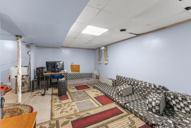 living room with a drop ceiling and washer / dryer