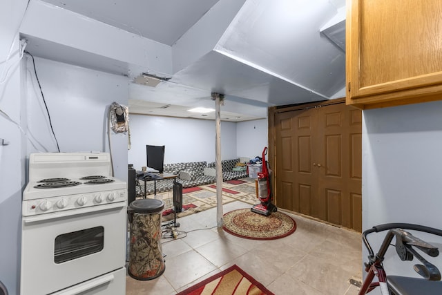 kitchen featuring light tile patterned floors and white gas stove