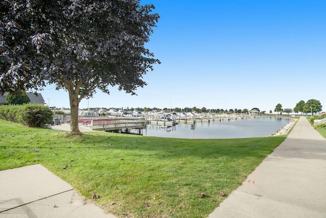 dock area featuring a yard and a water view