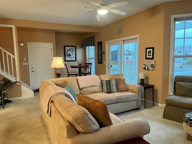 carpeted living room featuring plenty of natural light and ceiling fan