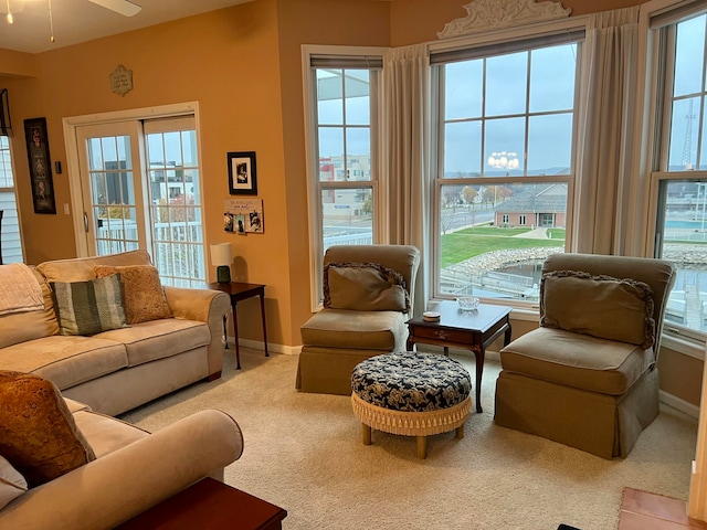 living room with ceiling fan and light colored carpet