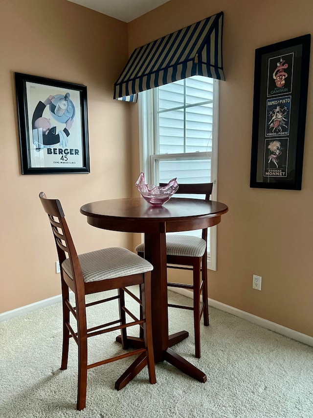 dining room featuring light carpet