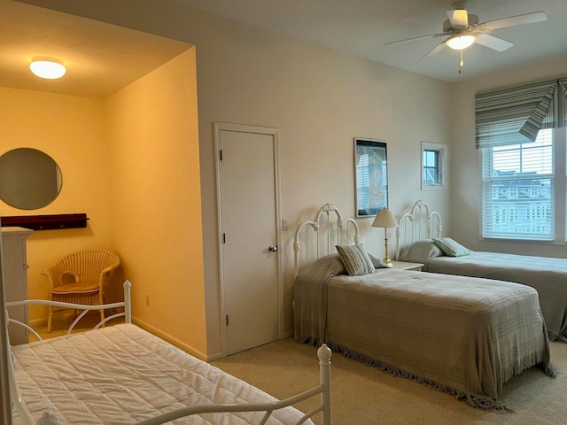 bedroom with ceiling fan and light carpet