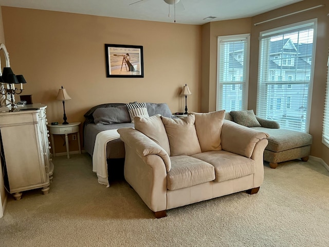 interior space featuring light carpet and ceiling fan