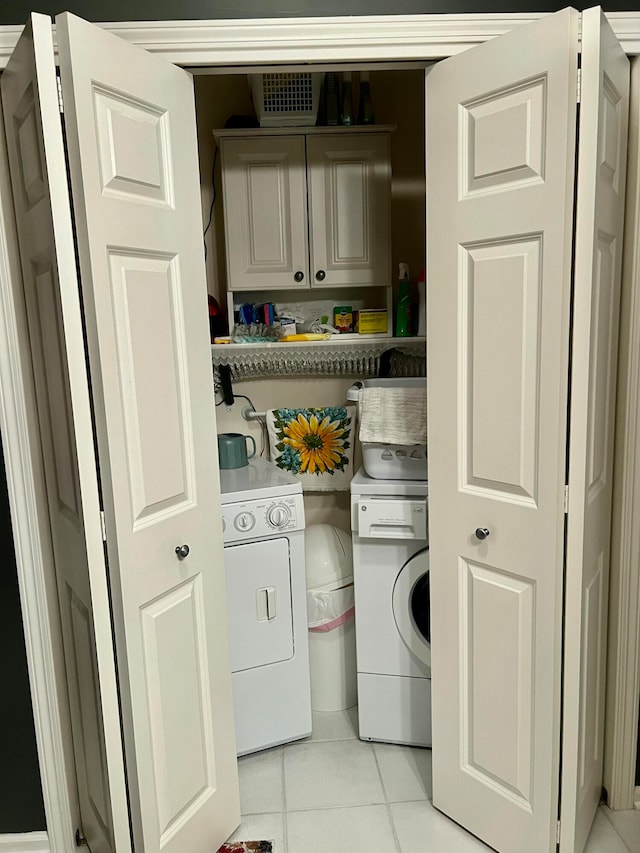 washroom featuring light tile patterned flooring, cabinets, and independent washer and dryer