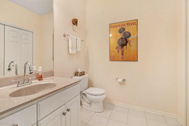 bathroom featuring tile patterned flooring, vanity, and toilet