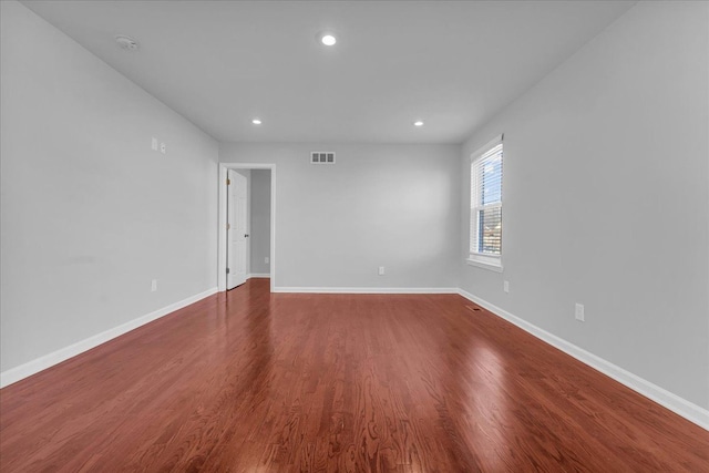 empty room with dark wood-type flooring