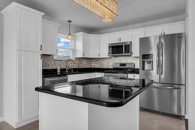 kitchen with decorative light fixtures, a center island, white cabinetry, and appliances with stainless steel finishes