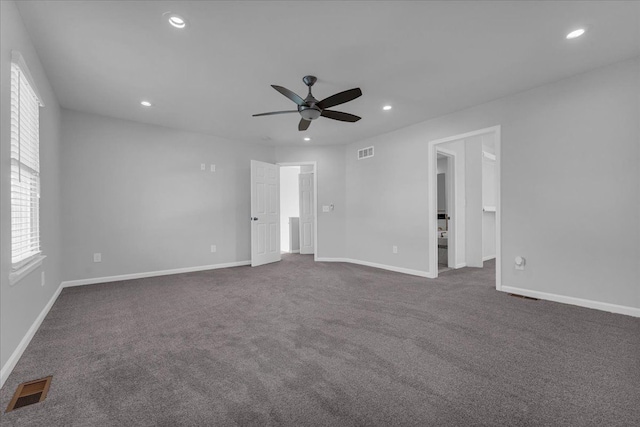 carpeted spare room featuring ceiling fan