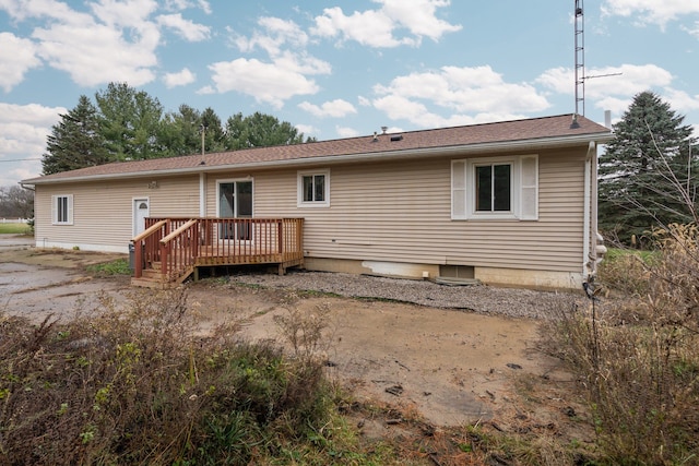 rear view of house featuring a deck