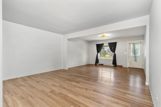 empty room with light hardwood / wood-style floors