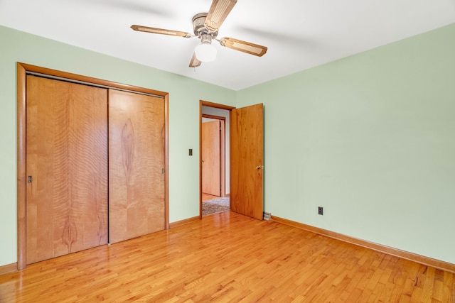 unfurnished bedroom with ceiling fan, light hardwood / wood-style floors, and a closet