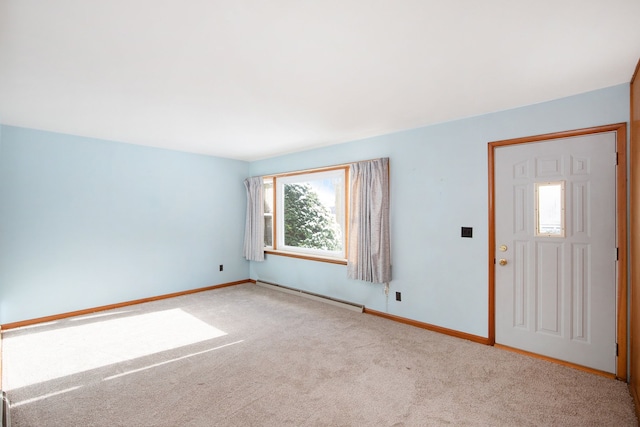 foyer entrance featuring a baseboard radiator and light colored carpet