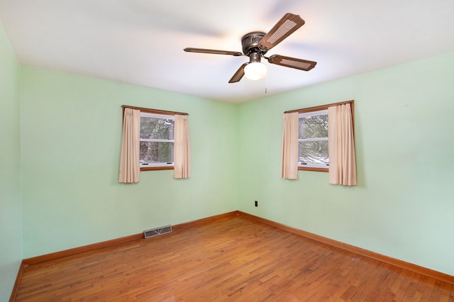 unfurnished room featuring hardwood / wood-style floors and ceiling fan