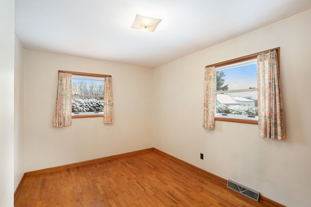 unfurnished room with hardwood / wood-style floors