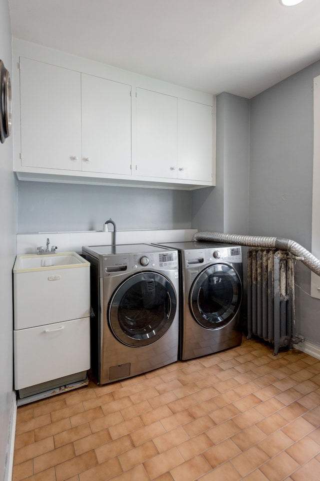 washroom with independent washer and dryer, cabinets, and radiator heating unit