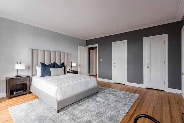 bedroom with crown molding and hardwood / wood-style flooring