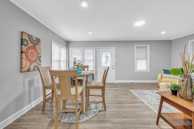 dining area with hardwood / wood-style flooring and a textured ceiling