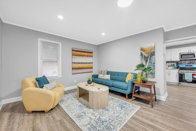 living room featuring ornamental molding and light hardwood / wood-style floors