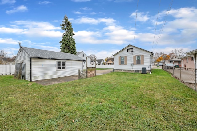 back of property featuring central AC unit, a patio area, and a lawn