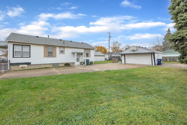 back of house featuring an outbuilding, a garage, and a lawn