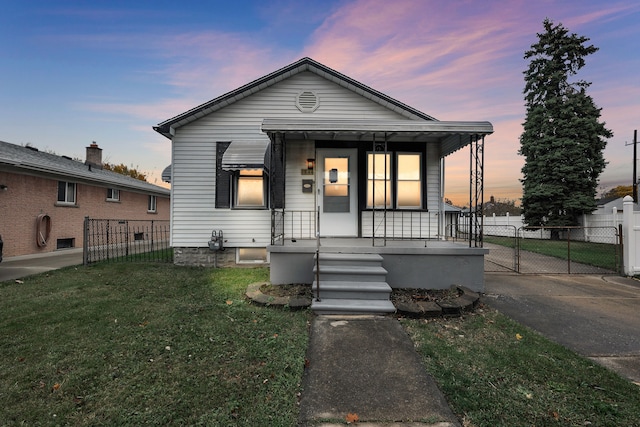 bungalow-style house featuring a porch and a yard