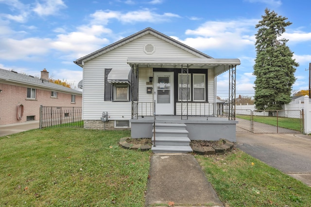 bungalow-style house with a front yard and covered porch