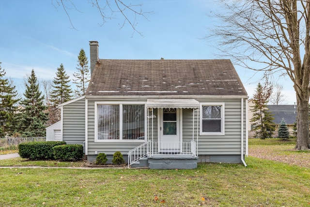 5570 Meadow View St, Sterling Heights, MI 48310 - view of front of house featuring a front yard, a chimney, and a shingled roof