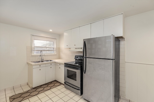 kitchen with backsplash, sink, light tile patterned floors, stainless steel appliances, and white cabinets