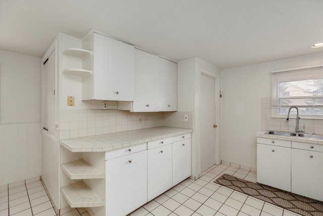 5570 Meadow View St, Sterling Heights, MI 48310 - kitchen with open shelves, a sink, white cabinets, backsplash, and tile countertops