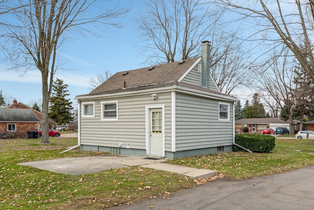 5570 Meadow View St, Sterling Heights, MI 48310 - back of property featuring a yard, a shingled roof, and a chimney