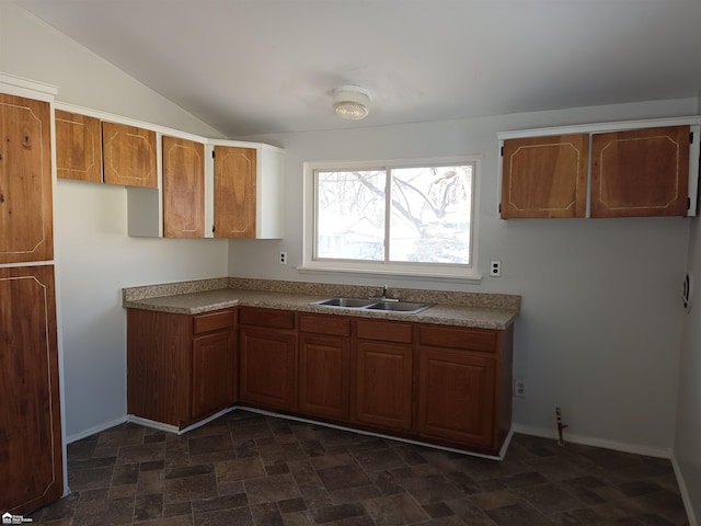 kitchen with sink and vaulted ceiling