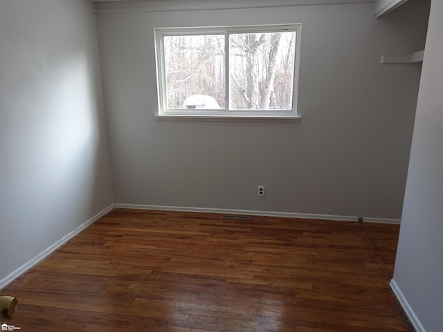 unfurnished room featuring dark wood-type flooring