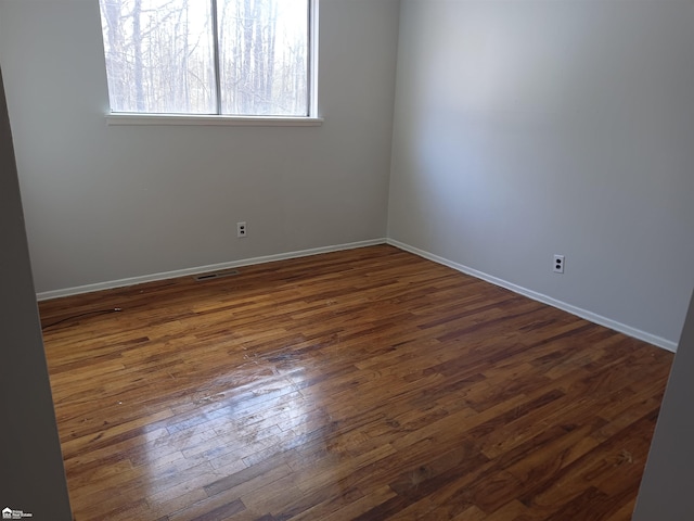 spare room with dark hardwood / wood-style flooring