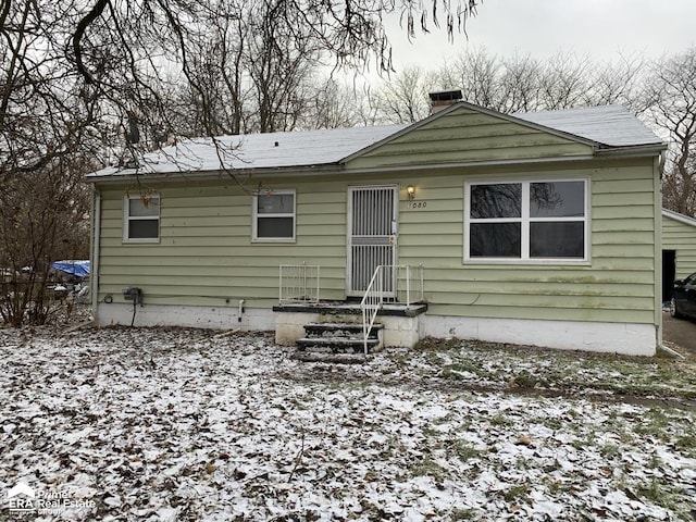 1080 E Cornell Ave, Flint, MI 48505 - snow covered rear of property with a chimney and roof with shingles