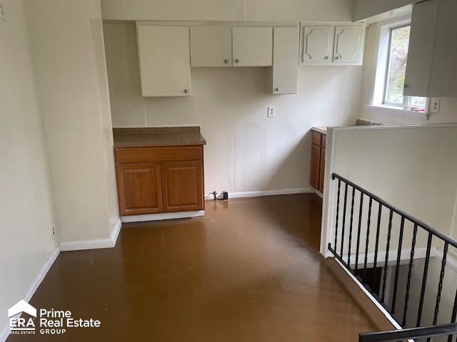 1080 E Cornell Ave, Flint, MI 48505 - kitchen with baseboards, white cabinetry, and dark wood finished floors