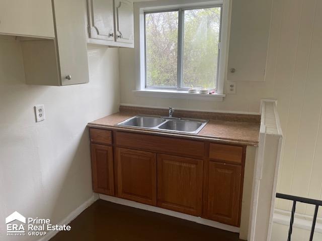 1080 E Cornell Ave, Flint, MI 48505 - kitchen with a sink and brown cabinetry