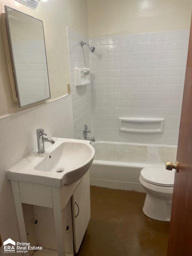 1080 E Cornell Ave, Flint, MI 48505 - bathroom featuring vanity, washtub / shower combination, and toilet