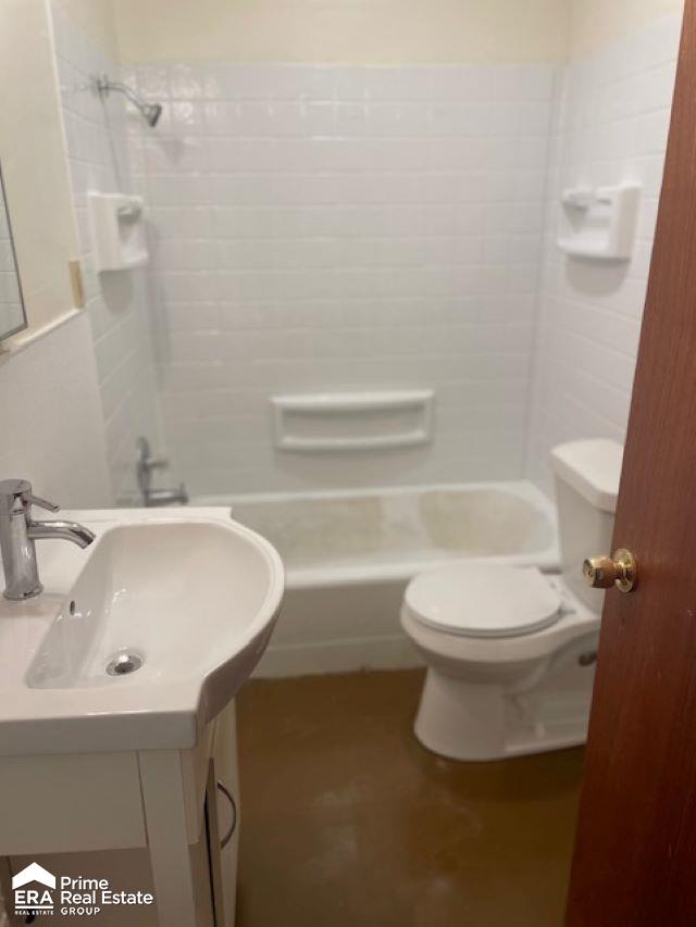 1080 E Cornell Ave, Flint, MI 48505 - bathroom featuring tub / shower combination, toilet, and vanity