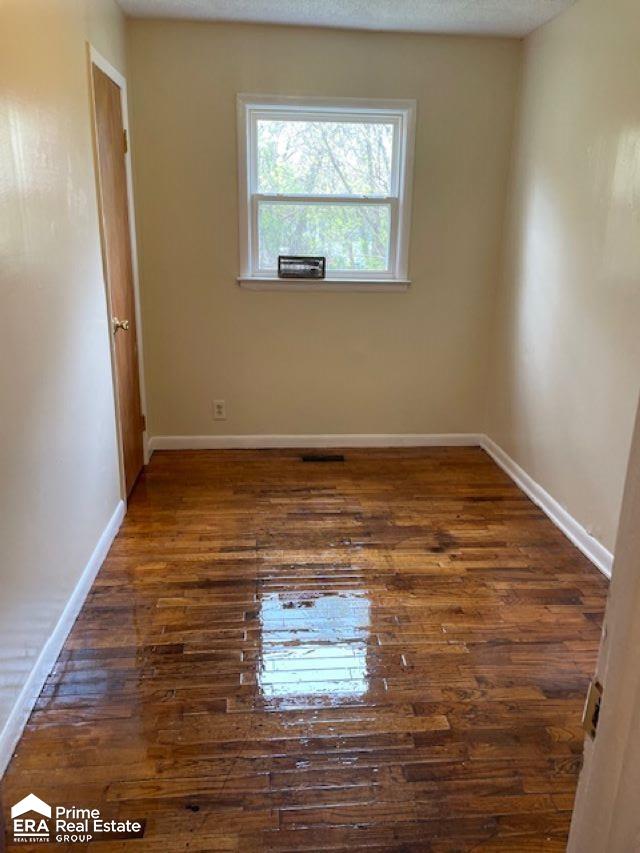 1080 E Cornell Ave, Flint, MI 48505 - spare room with hardwood / wood-style floors and baseboards