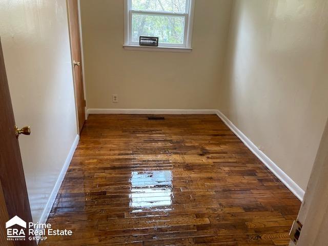 1080 E Cornell Ave, Flint, MI 48505 - unfurnished room featuring dark wood-type flooring and baseboards
