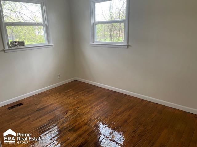 1080 E Cornell Ave, Flint, MI 48505 - unfurnished room featuring baseboards and dark wood-style flooring