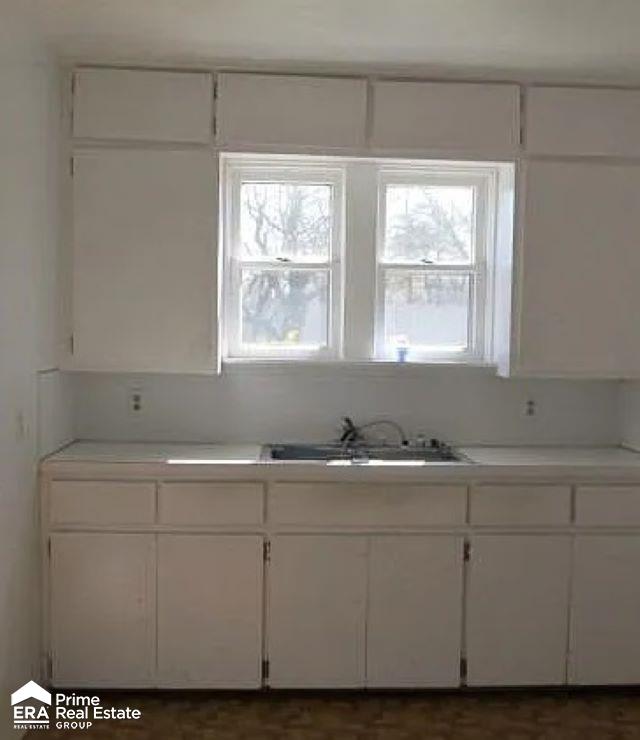 6458 Summit St, Mount Morris, MI 48458 - kitchen with a sink, white cabinets, and light countertops
