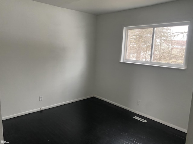 5509 Farmhill Rd, Flint, MI 48505 - spare room with baseboards and dark wood-type flooring