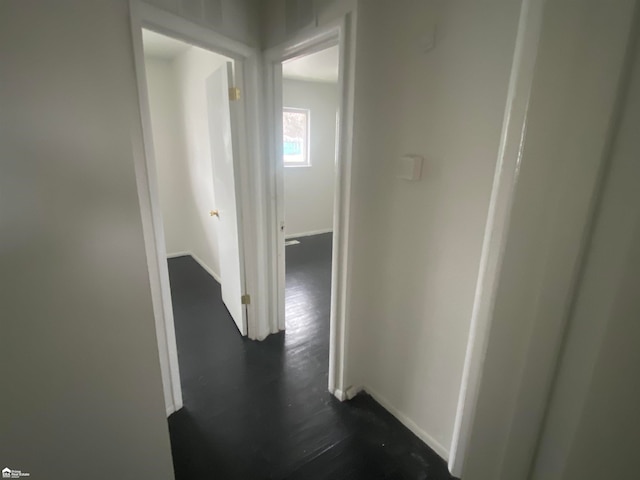 hallway with dark wood-type flooring