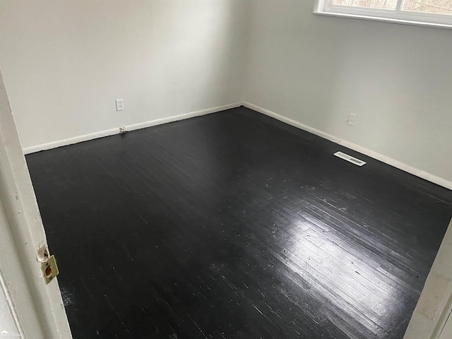 5509 Farmhill Rd, Flint, MI 48505 - unfurnished room with baseboards and dark wood-type flooring