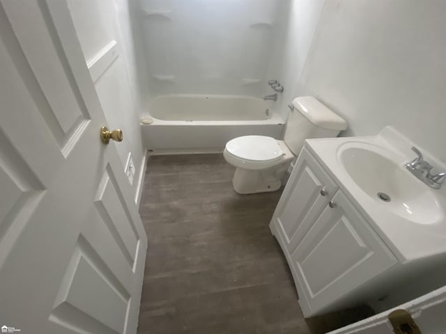 5509 Farmhill Rd, Flint, MI 48505 - bathroom featuring toilet, vanity, wood finished floors, and bathing tub / shower combination