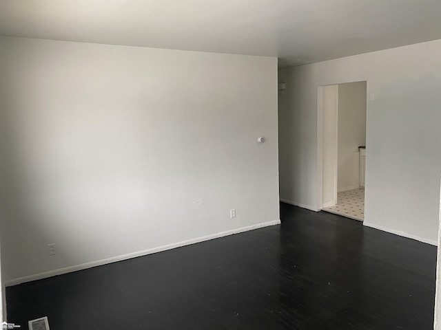 5509 Farmhill Rd, Flint, MI 48505 - empty room featuring dark wood-style flooring and baseboards